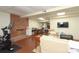 Finished basement rec room with brick fireplace, seating, workspace and peloton machine at 1638 Myers Park Dr, Charlotte, NC 28207