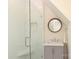 Bathroom featuring white subway tile shower with glass door and vanity with framed round mirror at 1638 Myers Park Dr, Charlotte, NC 28207