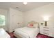 Comfortable bedroom with an upholstered headboard, double closets, and natural light from the window at 1638 Myers Park Dr, Charlotte, NC 28207