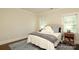 Cozy bedroom with plush bedding, side tables, and window with bright natural light at 1638 Myers Park Dr, Charlotte, NC 28207