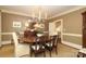 Elegant dining room with chandelier, wood table, and natural light at 1638 Myers Park Dr, Charlotte, NC 28207