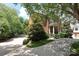 A beautiful two-story brick home shows off a manicured yard and a convenient parking area at 1638 Myers Park Dr, Charlotte, NC 28207