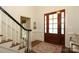 Inviting foyer with hardwood floors, a striking staircase, and a beautifully crafted front door at 1638 Myers Park Dr, Charlotte, NC 28207
