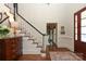 Elegant foyer featuring hardwood floors, a staircase, and a view into adjacent rooms at 1638 Myers Park Dr, Charlotte, NC 28207