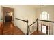 Upstairs hallway with hardwood floors and staircase at 1638 Myers Park Dr, Charlotte, NC 28207