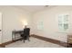 Bright home office featuring hardwood floors, built-in shutters, desk, and leather chair at 1638 Myers Park Dr, Charlotte, NC 28207
