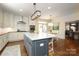 Well-lit kitchen with a large center island, modern appliances, and a view to the dining room at 1638 Myers Park Dr, Charlotte, NC 28207