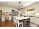 Modern kitchen features a center island, stainless appliances, and a convenient built-in desk at 1638 Myers Park Dr, Charlotte, NC 28207