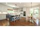 Bright kitchen with a center island, a breakfast table, and stainless steel appliances at 1638 Myers Park Dr, Charlotte, NC 28207