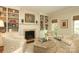 Inviting living room featuring built-in bookshelves, a fireplace, and comfortable seating at 1638 Myers Park Dr, Charlotte, NC 28207