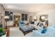 Bright living room with a fireplace, bookshelves, and cozy seating for gathering at 1638 Myers Park Dr, Charlotte, NC 28207