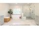 Luxurious main bathroom featuring a soaking tub, a glass shower, and double sinks at 1638 Myers Park Dr, Charlotte, NC 28207