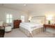 Bright main bedroom featuring plantation shutters, a ceiling fan, and a neutral palette at 1638 Myers Park Dr, Charlotte, NC 28207