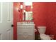 Quaint powder room with vibrant wallpaper, stylish fixtures, and a mirrored vanity at 1638 Myers Park Dr, Charlotte, NC 28207