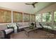 Relaxing screened-in porch with ceiling fan and comfortable seating for outdoor enjoyment at 1638 Myers Park Dr, Charlotte, NC 28207