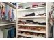 Organized walk-in closet with shelving for folded clothing and shoes, and hanging space for shirts and pants at 1638 Myers Park Dr, Charlotte, NC 28207