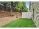 Backyard with white fence, faux turf, and pea gravel at 1915 Travertine Ln, Fort Mill, SC 29708