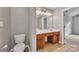 Well-lit bathroom features double sinks, sleek vanity, toilet, tile floor and modern fixtures at 1915 Travertine Ln, Fort Mill, SC 29708