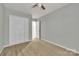 Bedroom features neutral carpet, ceiling fan and a closet, perfect for relaxation at 1915 Travertine Ln, Fort Mill, SC 29708