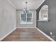 Bright dining room featuring hardwood floors, arched doorway, and a large window at 1915 Travertine Ln, Fort Mill, SC 29708