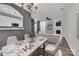 Bright and airy living room featuring a marble dining table, white sofa, fireplace, and a seamless flow to the kitchen at 1915 Travertine Ln, Fort Mill, SC 29708