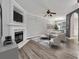 Cozy living room featuring a fireplace, a ceiling fan, and comfortable seating perfect for relaxation and entertaining at 1915 Travertine Ln, Fort Mill, SC 29708