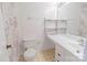 This half bathroom features tile flooring, a single sink vanity and a standard toilet at 2008 Bantry Ln, Charlotte, NC 28262