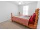 This cozy bedroom features carpeted floors, a ceiling fan, and a spacious closet at 2008 Bantry Ln, Charlotte, NC 28262
