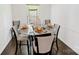 Formal dining area with modern table setting, hardwood floors, and neutral decor at 2008 Bantry Ln, Charlotte, NC 28262