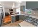 Updated kitchen with gray cabinetry, stainless steel appliances, and tiled backsplash at 2008 Bantry Ln, Charlotte, NC 28262