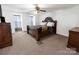 Spacious main bedroom offers a decorative ceiling fan, plush carpet and bright natural light at 2008 Bantry Ln, Charlotte, NC 28262