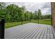 Relax on this new back deck featuring black metal railings overlooking a lush green backyard at 207 9Th Ne Ct, Conover, NC 28613