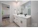 Modern bathroom with double vanity, sleek black fixtures, and view to the bedroom at 207 9Th Ne Ct, Conover, NC 28613