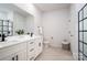 Contemporary bathroom boasts a double vanity, tile floors, and a glass-enclosed shower at 207 9Th Ne Ct, Conover, NC 28613