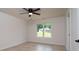 Neutral bedroom with view of green space, a ceiling fan and light-colored wood look floors at 207 9Th Ne Ct, Conover, NC 28613