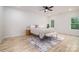 Bright bedroom features a comfortable bed with bench and a view of outdoors through multiple windows at 207 9Th Ne Ct, Conover, NC 28613