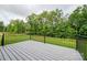 Outdoor deck with black metal railing overlooking a backyard with lush trees at 207 9Th Ne Ct, Conover, NC 28613