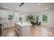 Open-concept kitchen and dining area with white cabinets, island, stainless appliances, and natural light from large windows at 207 9Th Ne Ct, Conover, NC 28613