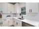Bright kitchen featuring white cabinets, stainless steel appliances, quartz countertops, and modern black faucet at 207 9Th Ne Ct, Conover, NC 28613