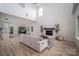 Spacious open-plan living room with a modern fireplace, light wood floors, and a cozy sofa at 207 9Th Ne Ct, Conover, NC 28613