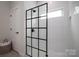 Modern shower has a glass enclosure with black trim, white subway tile, and a sleek shower head at 207 9Th Ne Ct, Conover, NC 28613