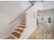Staircase leading to the second floor with a view of the open-concept kitchen and living area at 207 9Th Ne Ct, Conover, NC 28613