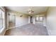 Spacious main bedroom with carpet, ceiling fan, and mirrored closet doors at 2377 Mintew Cir, Lincolnton, NC 28092