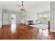 Open bonus room featuring hardwood floors, a chandelier, and neutral furnishings at 2521 Neely Store Rd, Rock Hill, SC 29730