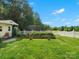 Backyard garden with raised beds and picket fence surrounded by lush green grass and mature trees at 2521 Neely Store Rd, Rock Hill, SC 29730