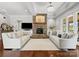 Elegant living room with a stone fireplace, hardwood floors, and comfortable seating at 2521 Neely Store Rd, Rock Hill, SC 29730