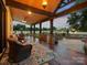 Expansive outdoor living space featuring a dining area, outdoor kitchen, and views of the lush surroundings at 2521 Neely Store Rd, Rock Hill, SC 29730