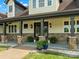 Inviting porch with stone pillars, elegant lighting, and beautifully landscaped surroundings at 2521 Neely Store Rd, Rock Hill, SC 29730