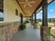 Extended porch featuring stone accents, ceiling fans, and scenic outdoor views at 2521 Neely Store Rd, Rock Hill, SC 29730
