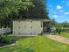 A backyard shed with a white picket fence is set amongst a backdrop of lush green grass at 2521 Neely Store Rd, Rock Hill, SC 29730